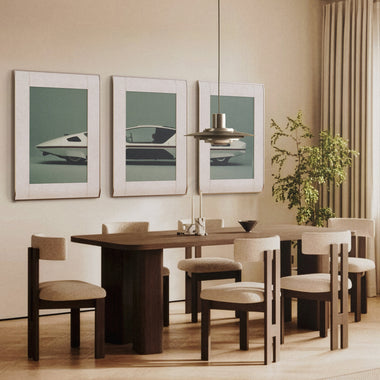 Modern dining room featuring three InkPoster digital art displays with minimalist automotive artwork mounted above a wooden dining table.