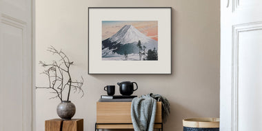 InkPoster displaying Asian-inspired poster art on a color ePaper display in a modern interior