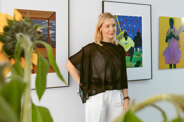 Kate Vass with InkPoster color ePaper digital art display during an interview