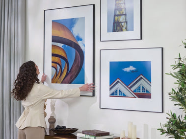 InkPoster color ePaper art display in a modern living room interior