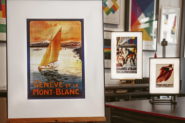 InkPoster displaying vintage poster artwork on a color ePaper display in a modern interior