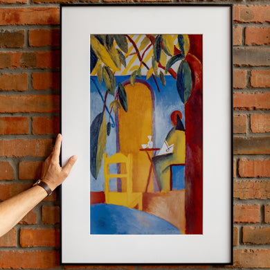 Hand positioning InkPoster Affresco 31.5 e-paper art frame on a red brick wall